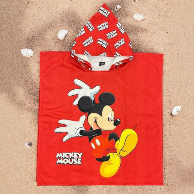 Red Mickey Mouse poncho towel with a logo patterned hood flat lay on sand