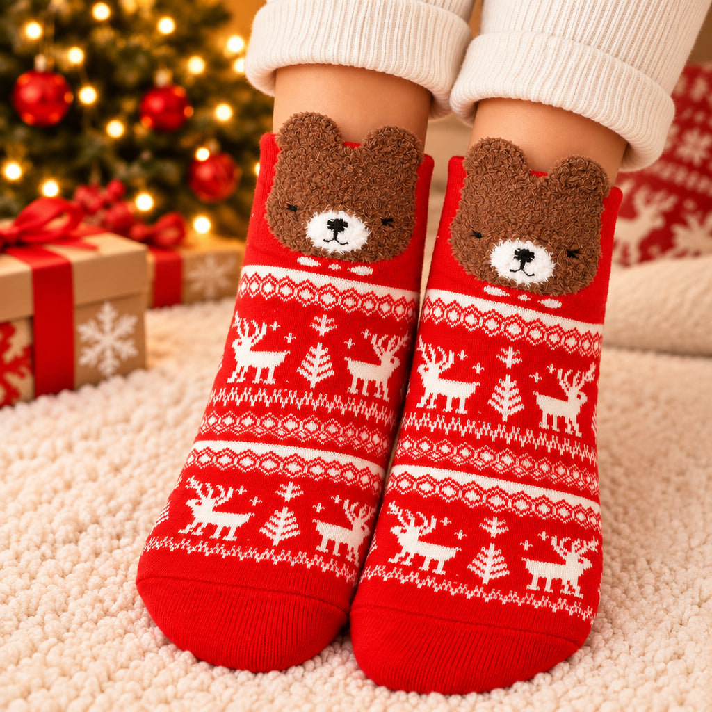 Red Nordic pattern Christmas socks with white reindeer and a fuzzy brown bear face at the cuff