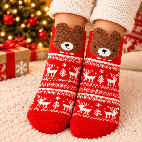 Red Nordic pattern Christmas socks with white reindeer and a fuzzy brown bear face at the cuff