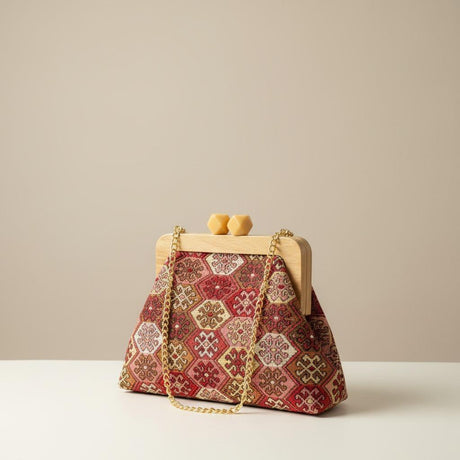 Red and cream patterned handbag isolated on a plain white surface