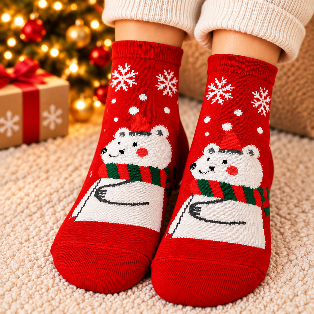 Red Christmas socks with white snowflakes and a polar bear wearing a red hat and striped scarf