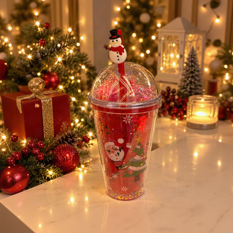 Red dome lid straw cup with Santa and tree print, pink tinsel inside and a snowman straw topper