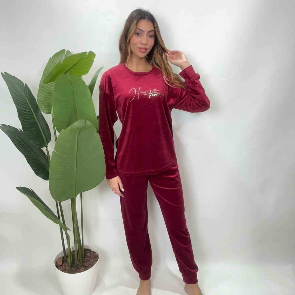 Red velvet pajama set with a long sleeve crew neck top and cuffed jogger pants
