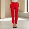 Person wearing red pants in a minimalistic room with a window