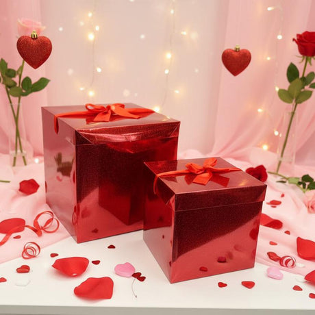 Shiny red gift boxes with satin bows among rose petals
