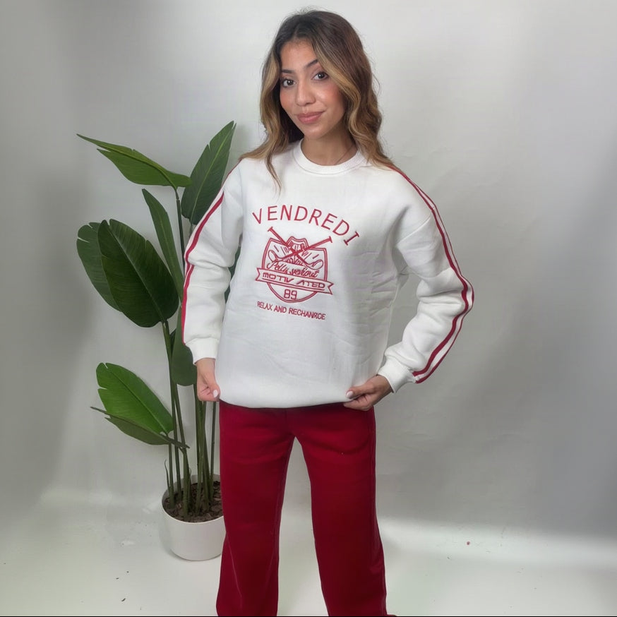 White sweatshirt with a red tiger crest varsity print, red sleeve stripes and red wide leg pants