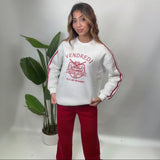 White sweatshirt with a red tiger crest varsity print, red sleeve stripes and red wide leg pants