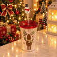 Clear straw tumbler with a reindeer print, red screw lid and a snowman straw topper