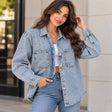 Woman in a light wash denim shirt jacket with scattered rhinestones and two chest pockets