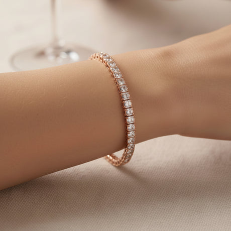 Rose gold square bracelet with diamonds on a wrist against a neutral background