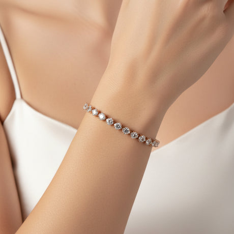 Rose gold tennis bracelet with clear gemstones worn by a person