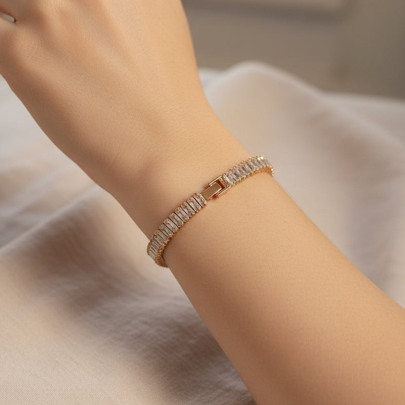 Rose Gold baguette tennis bracelet with a clasp worn by a person