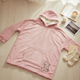 Pink hooded blanket laid flat showing the long sleeves, front pocket and bear motif