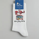 White sock with Arabic text and pixel art design on a white background
