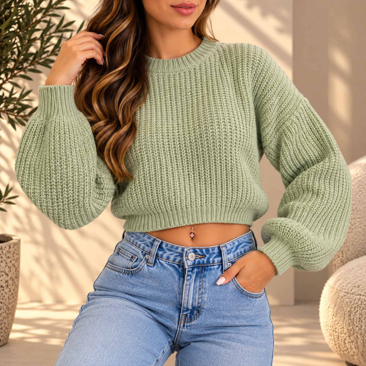 Woman in a sage green chunky ribbed knit cropped sweater with balloon sleeves and jeans