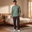 Men's sage green henley pyjama top with brown elbow patches and dark brown bottoms