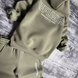 Sage green hoodie laid flat showing the off limits outline print on the back