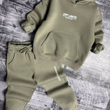 Sage green hoodie with kangaroo pocket and cuffed joggers laid flat