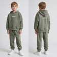 Boy shown front and back in a sage green hoodie set with off limits print