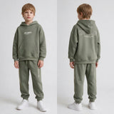 Boy shown front and back in a sage green hoodie set with off limits print