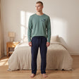 Men's sage green pyjama top with a navy horse motif and navy drawstring bottoms