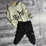 Sage New York hoodie and black cargo joggers on hangers
