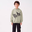 Boy in a sage New York hoodie and black cargo joggers, front view