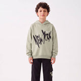 Boy in a sage New York hoodie and black cargo joggers, front view