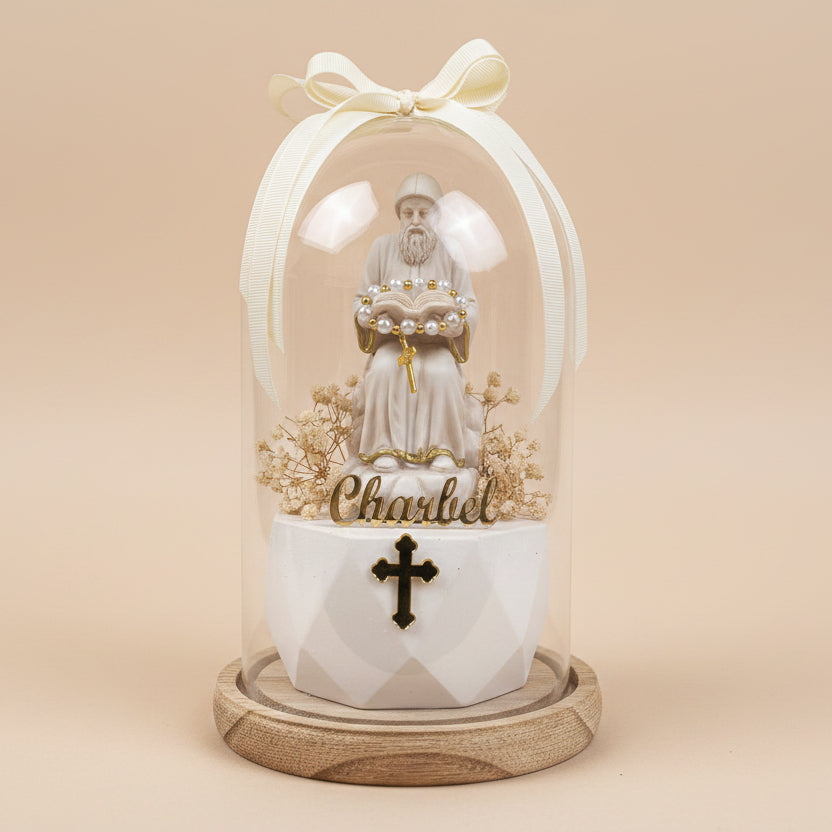 Pearls draped across the saint's open book over an ornate black and gold cross