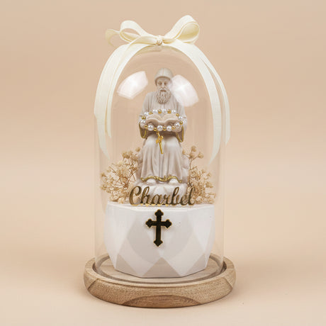 Pearls draped across the saint's open book over an ornate black and gold cross