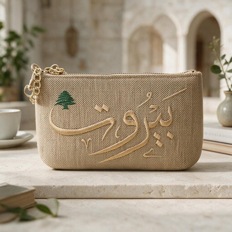 Natural jute look zip purse, Beirut calligraphy and cedar on the front, a teacup and arches in the background