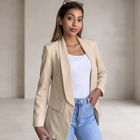 Sand beige shawl collar blazer worn open over a white top with light blue jeans