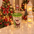 Clear straw tumbler with a Santa print, green lid and a Santa straw topper