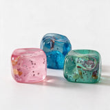Pink, blue and aqua jelly cube squishies with tiny seashells and star sparkles inside