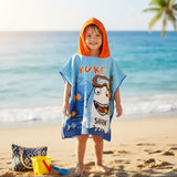 Boy wearing a blue shark poncho towel with a bright orange hood on the beach