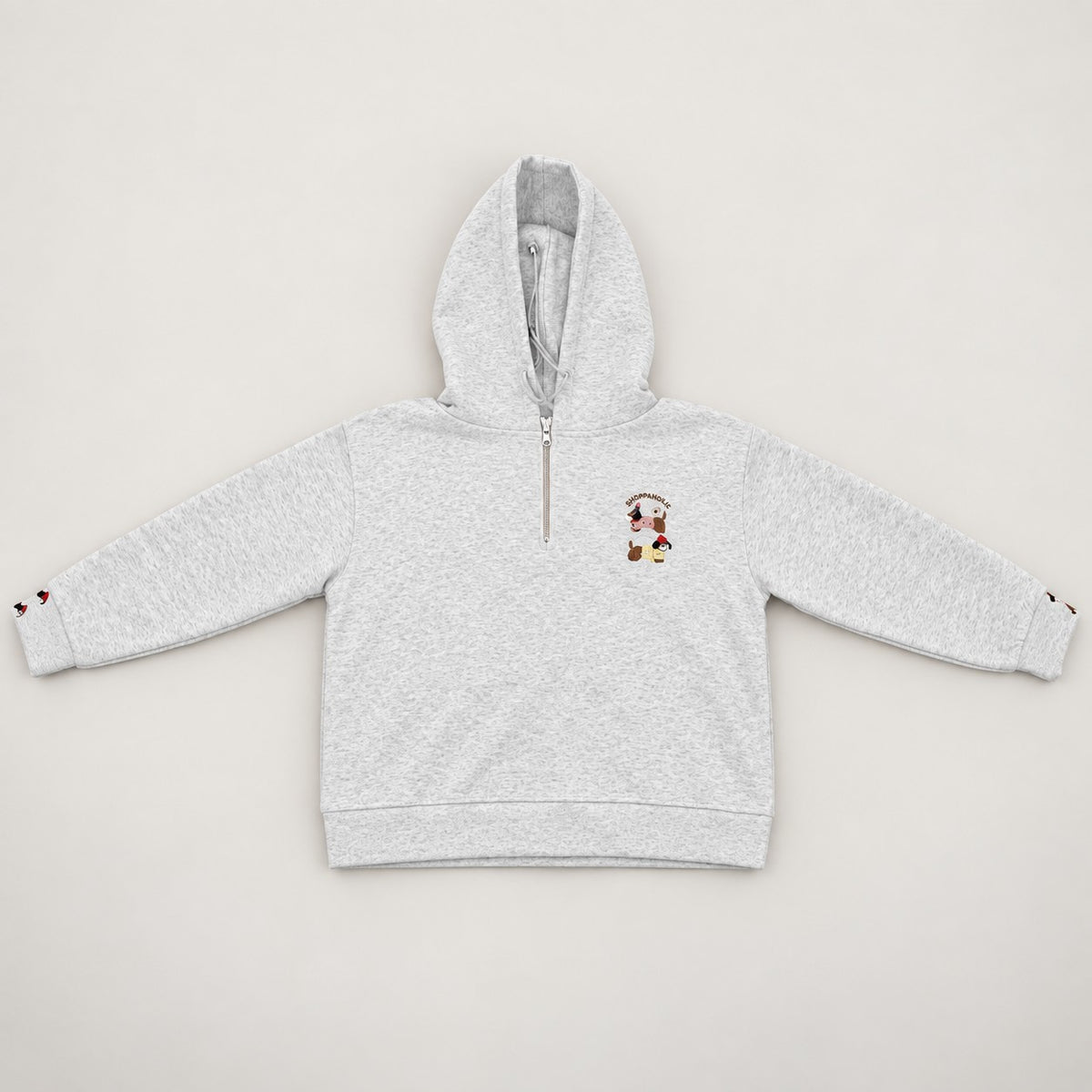 Flat lay of a grey marl hoodie with a quarter zip and small embroidered chest patch