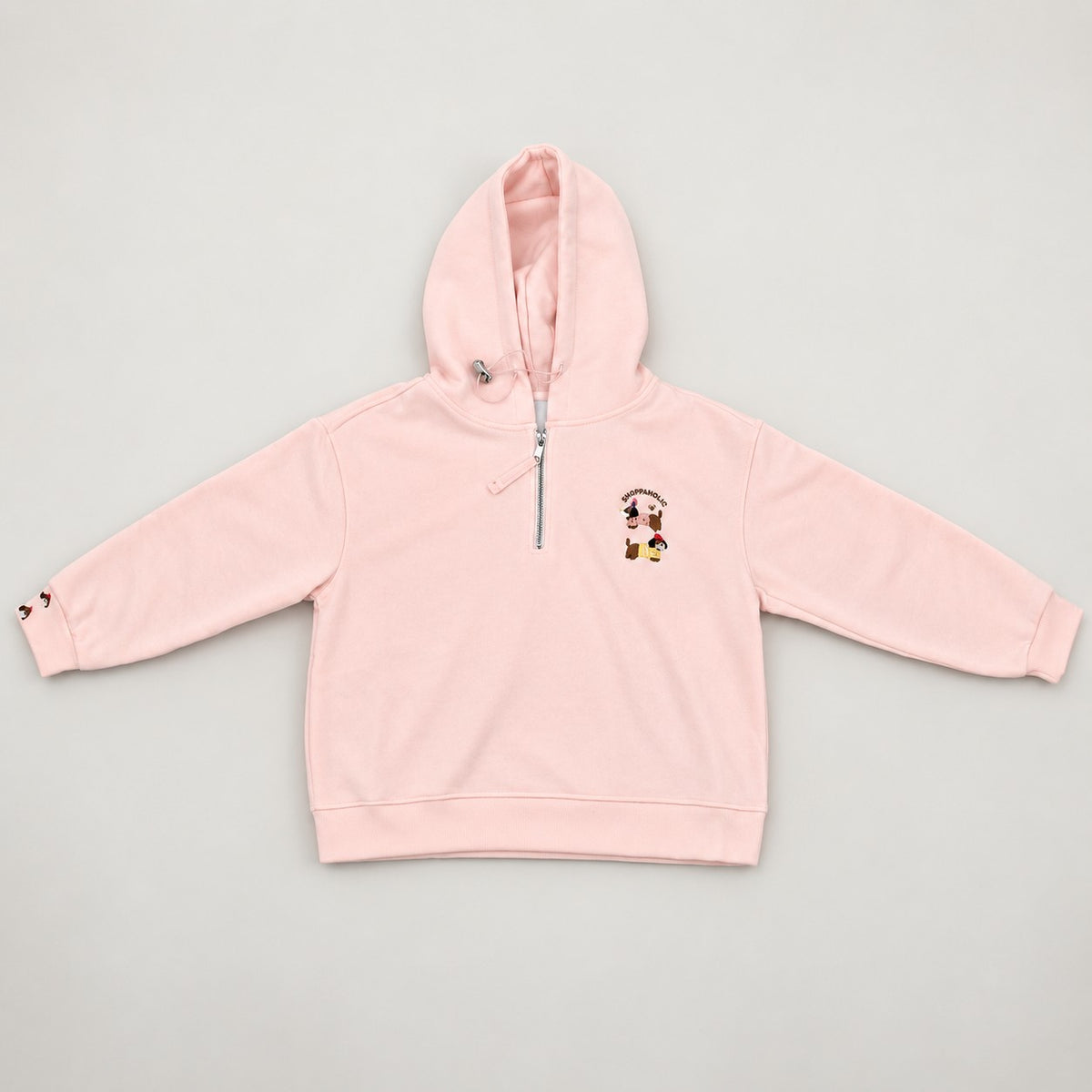 Blush pink hoodie flat on a plain background with its silver zip pulled halfway