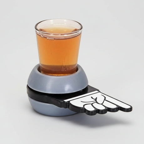 Shot spinner with a grey ball base, pointing hand arm and a shot glass of amber drink