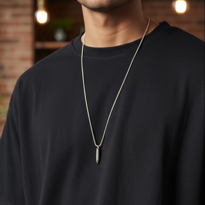 Silver bullet pendant on a slim box chain worn over a black tee, Jack Gifts Online Lebanon