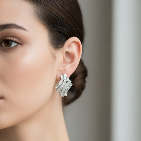 Close-up of a woman wearing a silver earring with a blurred background