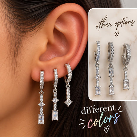 Ear wearing three silver pave huggies with long baguette and round crystal drops