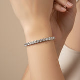 Silver square bracelet with clear stones on a person's wrist