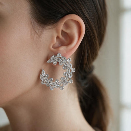 Silver crystal wreath open circle earring with marquise and round stones worn on the ear