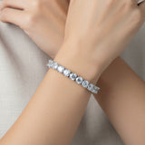 Silver deluxe tennis bracelet with clear stones on a person's hand