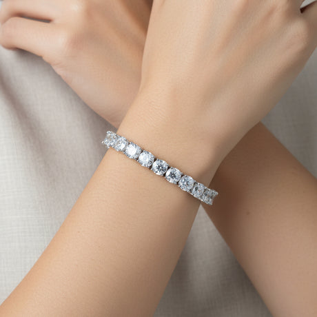 Silver deluxe tennis bracelet with clear stones on a person's hand