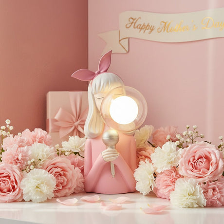 Blonde singer figure with her silver microphone banked in roses and carnations