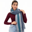 Woman in a burgundy top wearing a slate blue brushed scarf with a teal and grey stripe and fringe
