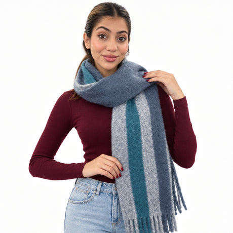 Woman in a burgundy top wearing a slate blue brushed scarf with a teal and grey stripe and fringe