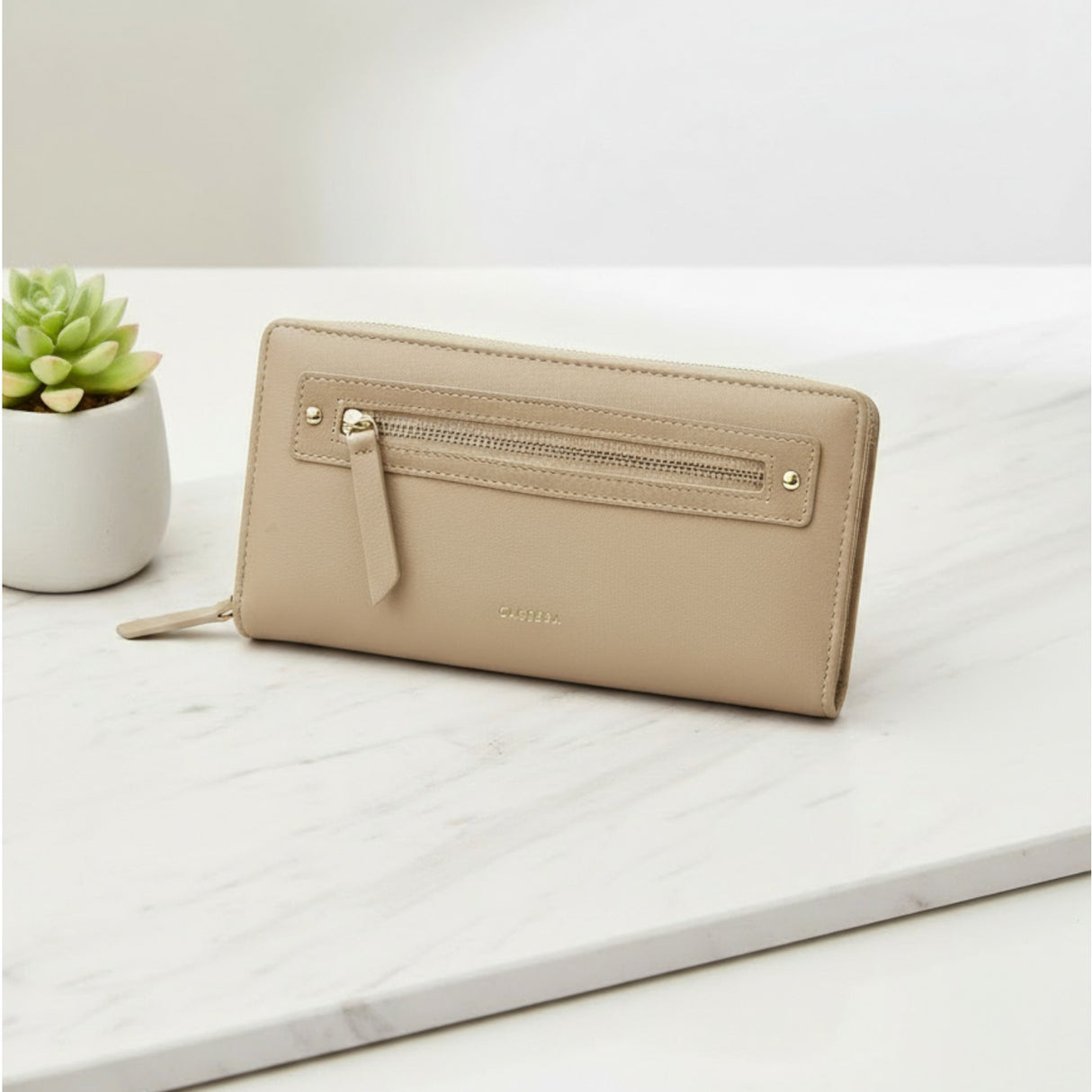 Beige women's wallet with a sleek gold zipper detail