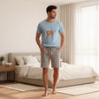 Sloth print pyjama set worn standing in a sunlit bedroom